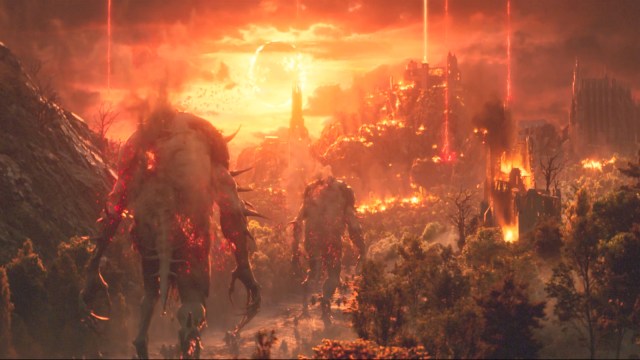Towering creatures in Lords of the Fallen traverse through an environment ravaged by fire.