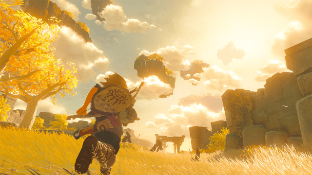 Link runs towards an open sky, surrounded by fields of golden grass and trees with yellow leaves.